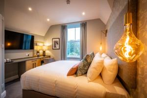 a bedroom with a large bed with a large window at Ambleside Fell Rooms in Ambleside