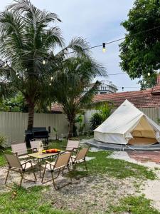 a group of chairs and a table and a tent at Lasam Heritage Villa + Glamping in the House 24pax with Karaoke & Snooker in Ipoh