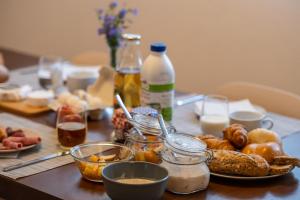 a table topped with a plate of food and bottles of milk at Montela Hotel & Resort - Suiten in Saas-Grund