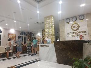a group of people walking through a sunflower hotel lobby at Huong Duong Sunflower in Ha Long