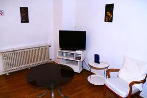 a living room with a tv and a coffee table at Koblenzerstraße 16 in Bad Ems