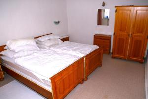 a bedroom with a large wooden bed with white sheets at Koblenzerstraße 16 in Bad Ems