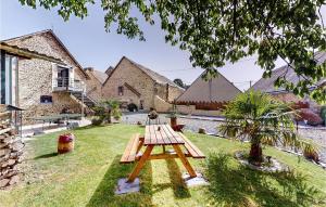 a picnic table in the yard of a house at Gorgeous Apartment In Neuilly Le Vendin With Wifi in Neuilly-le-Vendin