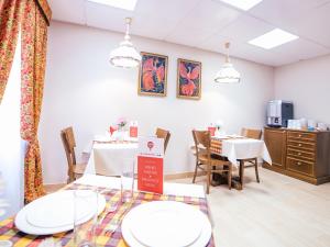 a dining room with white tables and chairs at Boutique Hotel Countries in Samara