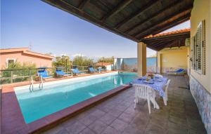 a patio with a table and chairs next to a pool at Villa Spera in Mandra Capreria