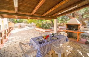 a table and chairs on a patio with a fireplace at Villa Spera in Mandra Capreria