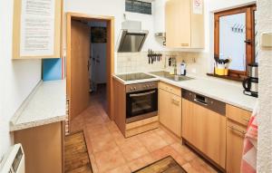 a kitchen with a sink and a stove at Stunning Home In Nahetal-waldau With Sauna in Hinternah