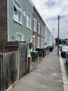 Une rangée de maisons dans une rue avec une clôture dans l'établissement Just Plan B Homes, à Forest Hill