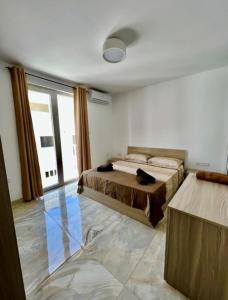 a bedroom with a bed and a large window at Saint Henry Sliema in Sliema