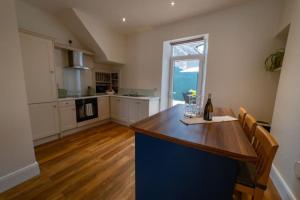 a kitchen with a table with a bottle of wine at 4 Connaught Street Birr in Birr