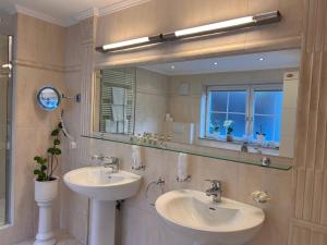 a bathroom with two sinks and a mirror at SONNENLODGE St Anton am Arlberg in Sankt Anton am Arlberg