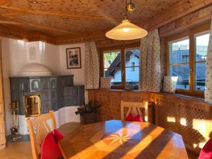 a dining room with a table and some windows at SONNENLODGE St Anton am Arlberg in Sankt Anton am Arlberg