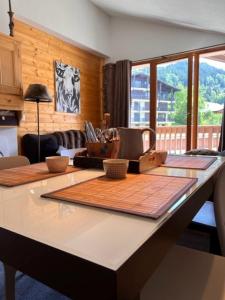 a kitchen with a counter top with wooden counter tops at Residence Labellemontagne Le Village in Notre-Dame-de-Bellecombe