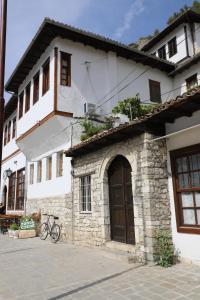 a bike parked in front of a building at Badejani Room in Berat