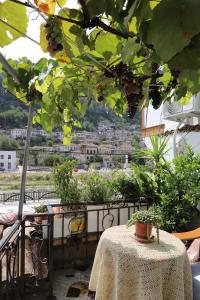 a table with a view of a city from a balcony at Badejani Room in Berat +2 photos