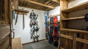 a room with skis and snowboards on the wall at Chalet Chal'heureux in Chamonix-Mont-Blanc