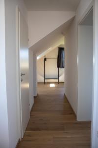 an empty hallway with white walls and wood floors at Elmi 33 in Wals
