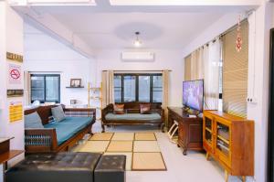a living room with a couch and a tv at LD8 House Private Pool Perfect Groups -Families ChiangMai in Chiang Mai +48 photos