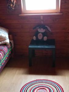 a teddy bear sitting on a table in a room at DOMEK LETNISKOWY PRZY GÓRACH MAJOWYCH in Goniadz