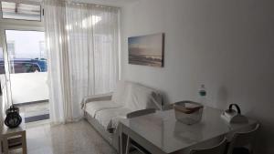 a living room with a white couch and a table at CASA FABi in Arrieta