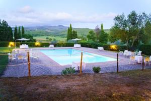 a swimming pool with tables and chairs around it at Pian Dei Mucini Resort in Massa Marittima +138 photos
