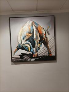 a painting of a bull hanging on a wall at Hostal San Cayetano in Ronda