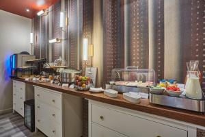 a buffet line in a hotel with food on it at Hôtel LUX PICPUS in Paris