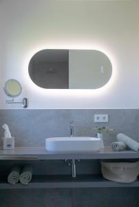 a bathroom with a sink and a mirror at Elmi 33 in Wals