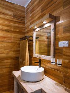 a bathroom with a white sink and a mirror at Limiria Villa Zanzibar in Nungwi