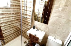 a bathroom with a sink and a shower and a toilet at Saint Henry Sliema in Sliema