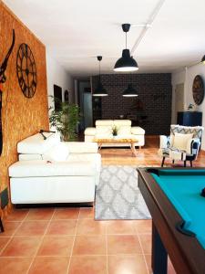 a living room with couches and a pool table at Las Palmeras in Alberique