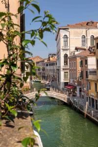 a bridge over a river in a city with buildings at Charming Palace Santa Fosca in Venice