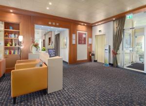 a lobby with a waiting room with a yellow chair at Trip Inn Landhotel Badsoden-Salmünster in Bad Soden-Salmünster