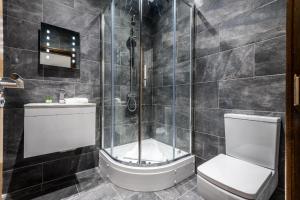 a bathroom with a shower and a toilet and a sink at 27 Stanley Street Aparthotel by UStay in Liverpool