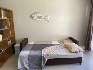 a bedroom with a bed with a fish on the wall at Appartamento Azure 23 - Big Bay in Big Bay