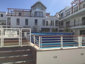 a building with a swimming pool on top of a building at Appartamento Azure 23 - Big Bay in Big Bay