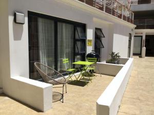 a patio with a table and chairs in a building at Appartamento Azure 23 - Big Bay in Big Bay