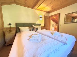 a bedroom with two beds with towels on them at Ferienhaus Gipfelstürmer in bayerischer Idylle in Bayrischzell