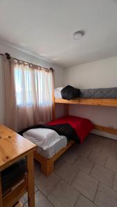 a bedroom with two bunk beds and a desk at Las Cabañitas dp2 in San Carlos de Bariloche