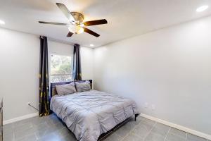 a bedroom with a bed and a ceiling fan at By the Beach - In-Law Suite in Jacksonville