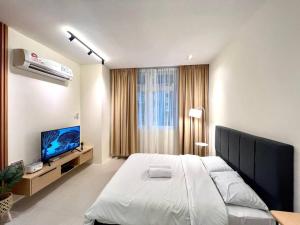クチンにあるElegant Riverine Diamond Homestay With Poolの大きなベッドと薄型テレビのある寝室 +34枚の写真