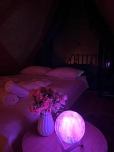 a room with two beds and a vase with flowers at Panorama Sarpi in Batumi