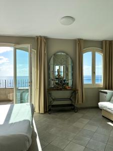a bedroom with a bed and a view of the ocean at Torremare in Marine du Miomo