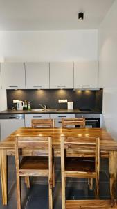 a kitchen with a wooden table and chairs at Starfish apartment in Paje