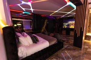 a bedroom with a bed in a room with lights at Krystalisya Room Suite Spa Privatif Sauna Jacuzzi Siege Massant in Marseille