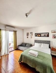 1 dormitorio con 1 cama grande y 1 sofá en lindo departamento a 2 cuadras del obelisco en Buenos Aires