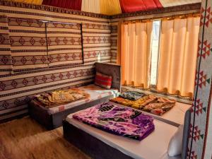 a room with two beds in a room with curtains at Wadi Rum Camp & Jeep Tour in Wadi Rum