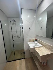 a bathroom with a sink and a shower at Flat Saint Paul Jardim Paulista Magnifico! in Sao Paulo