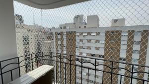 a balcony with a fence and some buildings at Flat Saint Paul Jardim Paulista Magnifico! in Sao Paulo
