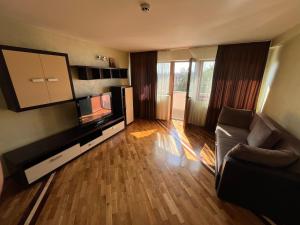 a living room with a couch and a flat screen tv at Complex Ramiro in Suceava